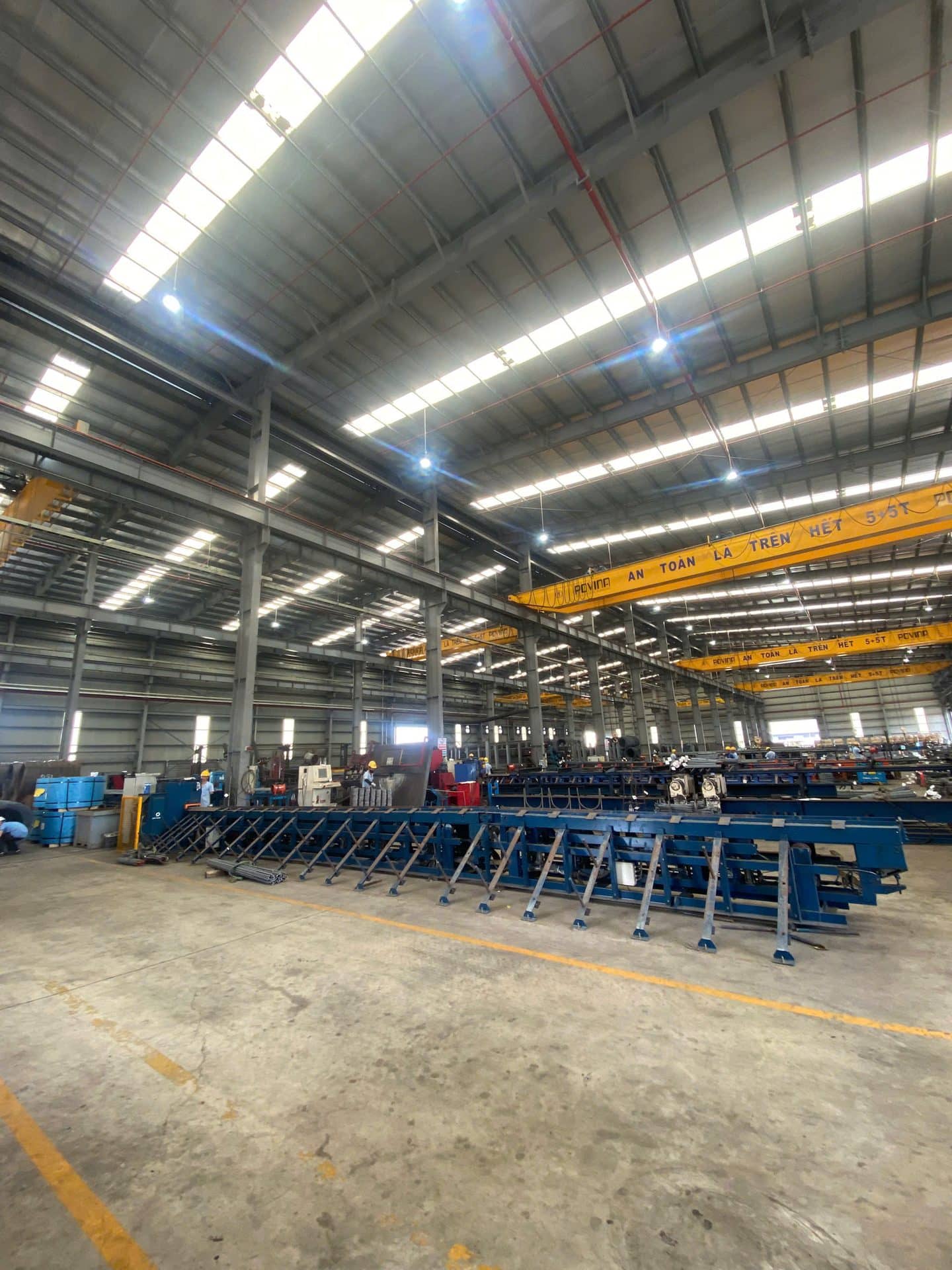 Fabricated metal frames staged on the floor of a metal manufacturing plant
