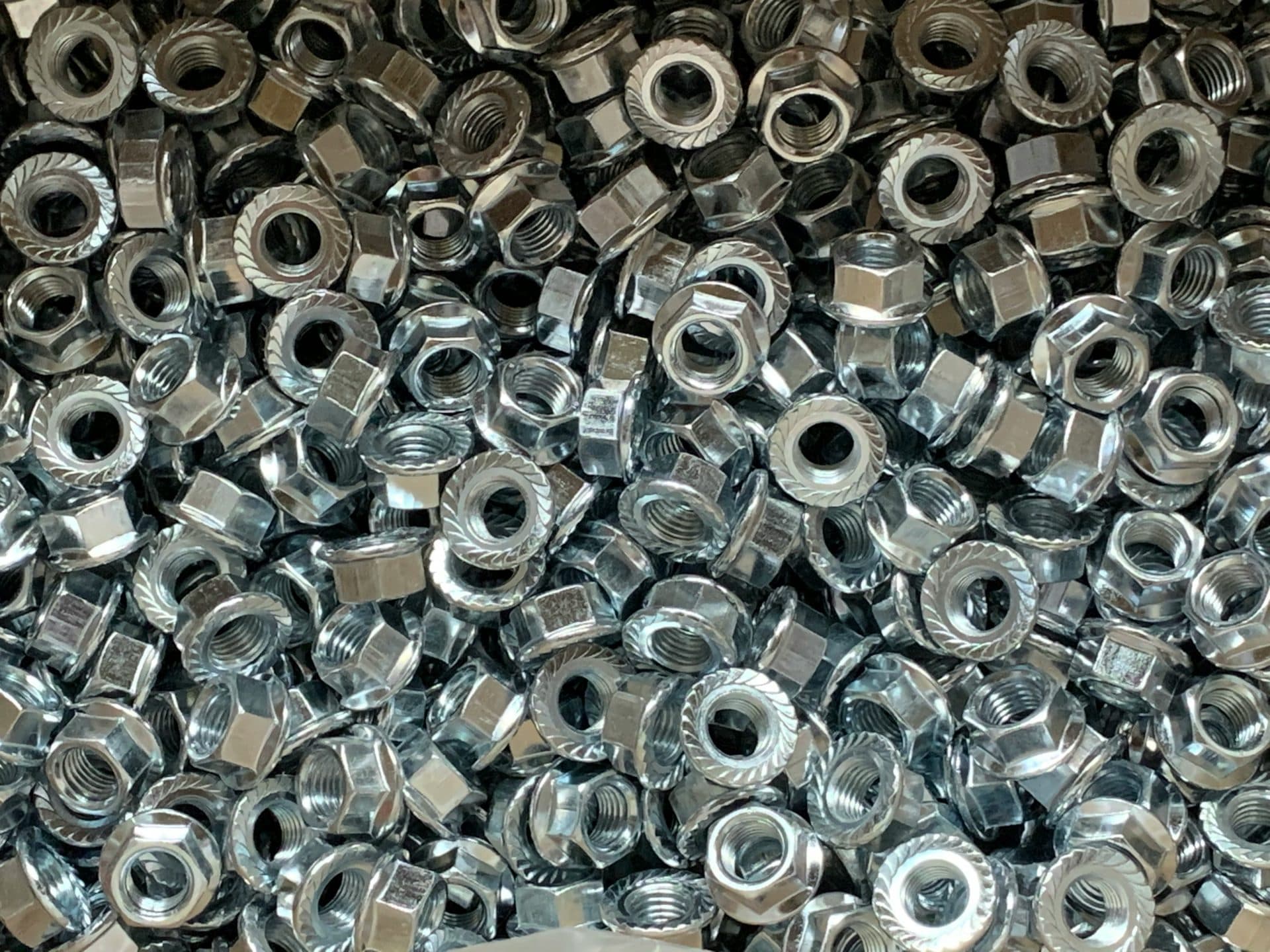 Progressive-die stamped metal parts beside a strip or press area