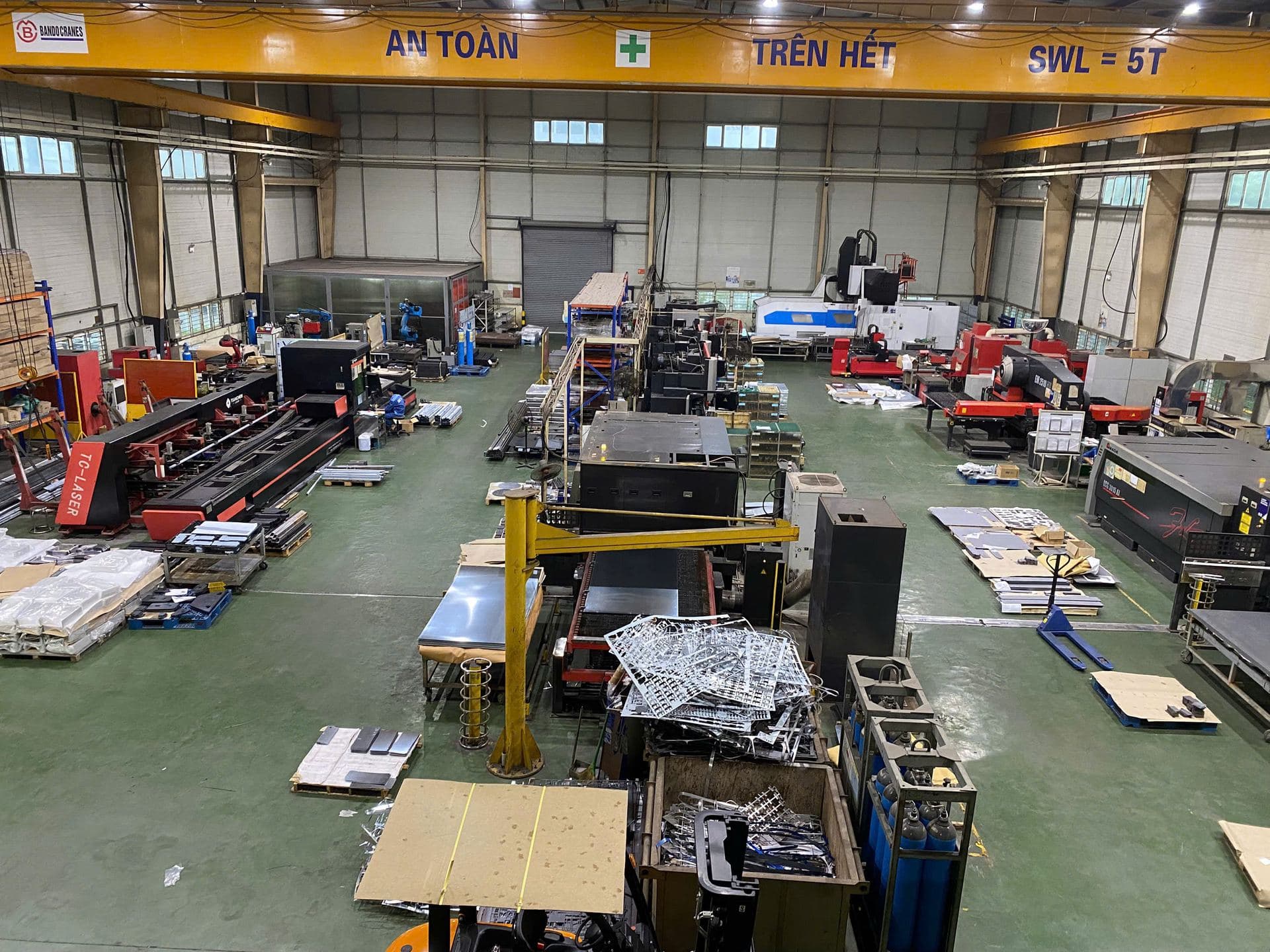 Buyer or engineer reviewing metal parts drawings in a factory meeting area